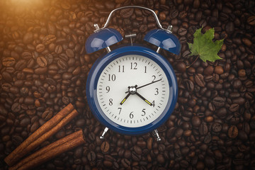 Roasted coffee beans, cinnamon sticks and alarm clock. Wake up. Good morning. Autumn mood....