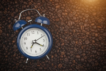 Roasted coffee beans and alarm clock. Wake up. Good morning. Background, close-up view.