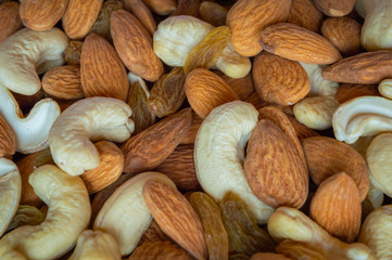 Close up top view of nuts cashew almonds raisins spread on table