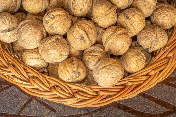 Walnuts in a wooden bowl on a wooden table walnuts with shells