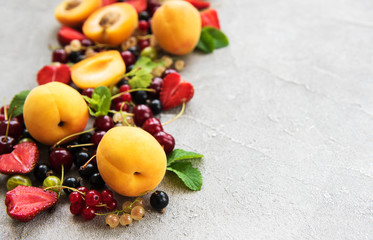 Fresh summer fruits on a concrete background