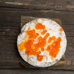 Rice crackers with smoked salmon spread on old wooden surface