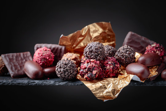 Various chocolates on a black background.