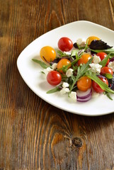 Green salad with cherry tomatoes and cottage cheese, vertical, top view 