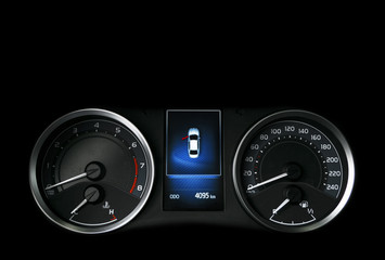 Close up shot of a speedometer in a car. Car dashboard. Dashboard details with indication lamps.Car instrument panel. Dashboard with speedometer, tachometer, odometer. Car detailing. Modern interior