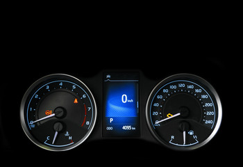 Close up shot of a speedometer in a car. Car dashboard. Dashboard details with indication lamps.Car instrument panel. Dashboard with speedometer, tachometer, odometer. Car detailing. Modern interior