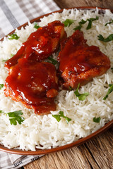 Chicken thighs baked with Catalina sauce served with rice. vertical