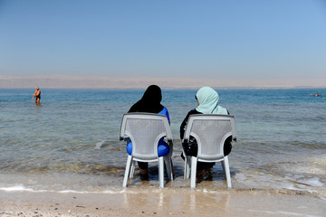 Dead Sea, Amman Beach,Jordan - September 28: vacationers and tourists bathe in the Dead Sea with Dead Sea mud in Amman Beach, Jordan