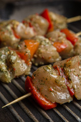 Skewers with raw meat on grill pan