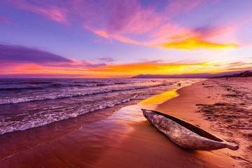 Lake Malawi sunset in Kande beach Africa, canoe boat on beach peaceful beach holiday beautiful sunset colors blue purple orange yellow in sky and clouds - obrazy, fototapety, plakaty