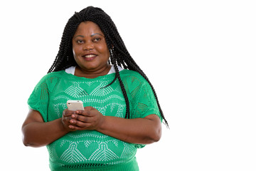 Studio shot of happy fat black African woman smiling and thinkin