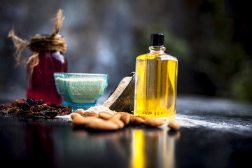 Close up of herbal face pack for removing black and white heads on wooden surface i.e. Multani mitti or fuller's earth with rose water and almond oil.