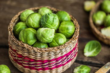 Many Fresh Green Brussels Sprouts in a Basket