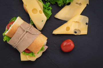sandwich with  with ham, cheese, tomatoes, lettuce on  over stone. Top view with copy space