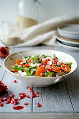 Carrot salad with a mixture of grains, mint and pomegranate. The concept of healthy,  seasonal food 
