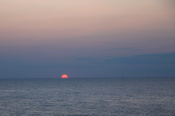 The sun sets in the sea.