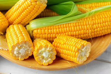 Raw corn on a wooden table