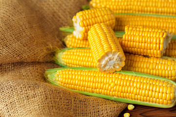 Raw corn on a wooden table