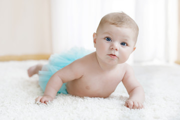 Adorable baby girl on white background wearing turquoise tutu skirt. © Irina Schmidt