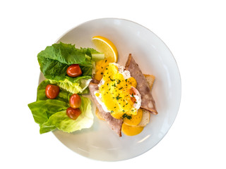 Eggs Benedict is a traditional American breakfast or brunch dish. Compatible with fresh salad, topped with ham or bacon, poached egg, and hollandaise sauce. The dish was first popularized in New York.