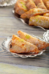 Turkish sweets baklava and metal oriental tray on wooden background