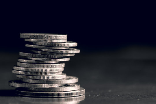black and white photo of a stack of coins