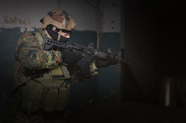 A army soldier takes aim with a rifle in his hands. Storming the building concept.