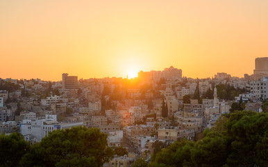 Obraz premium Amman, Jordan its Roman ruins in the middle of the ancient citadel park in the center of the city. Sunset on Skyline of Amman and old town of the city with nice view over historic capital of Jordan.