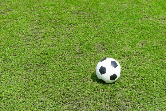 football field  ball on green grass , soccer field athletics background