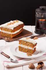 Delicious sliced carrot cake and tea on table