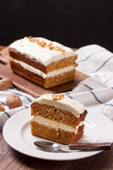 A slice of carrot cake on wooden background