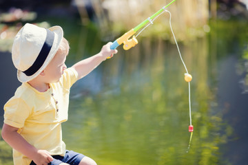 Toddler boy fishing in the lake
