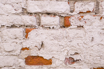 old vintage brick wall with shabby white paint background. architecture, texture.