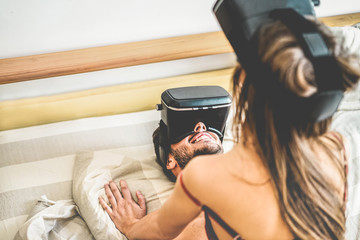 Young using virtual reality glasses for sex in bedroom