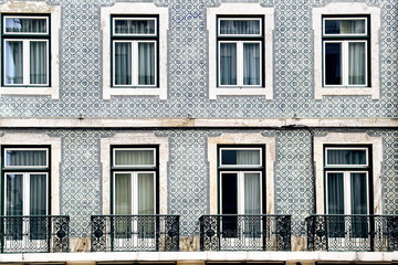 Lisbon windows with typical portuguese tiles on the wall