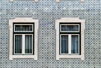 Lisbon windows with typical portuguese tiles on the wall