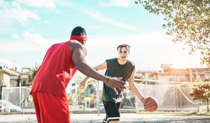 Happy athletes friends playing basketball outdoor in city urban contest