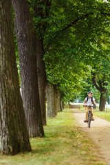 Handsome boy on the bicycle, summer day