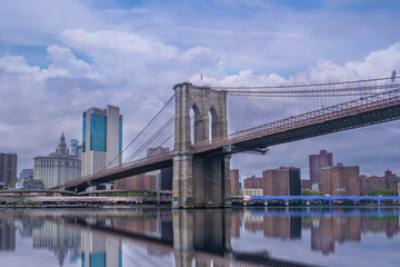 Brooklyn Bridge in New York City at  clounds sky, Skyline of downtown New York, USA