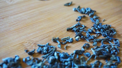 scattered green tea on wood bamboo background             