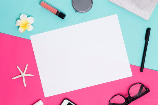 White A4 blank frame on a colorful pink and blue background with womens accessories