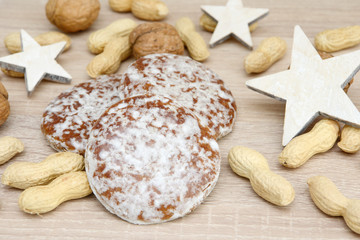 gingerbread, walnuts, wooden star  and peanuts on wood
