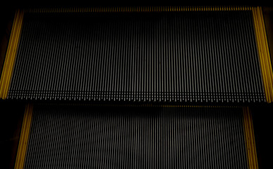 abstract escalator in shopping mall, Moving up staircase, yellow bands. metal line steel