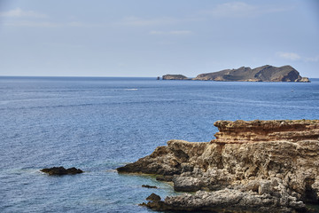 Fototapeta na wymiar View of beautiful beach in Cala Salada bay famous for its azure crystal clear sea water, Ibiza island, Spain
