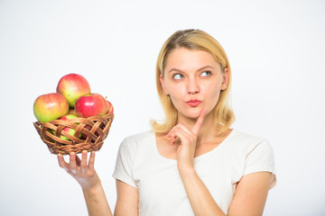 Girl hold basket apples white background. Culinary recipe concept. Woman thoughtful face come up with idea what to cook. Easy culinary ideas. Apple main ingredient. Apple recipes to make this fall