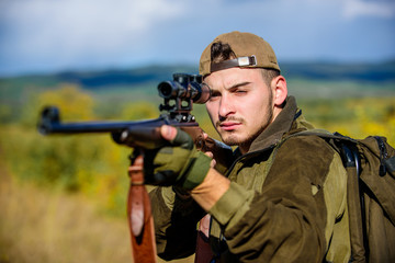 Guy hunting nature environment. Hunting weapon gun or rifle. Man hunter aiming rifle nature...