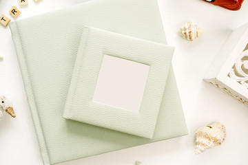 Photo album on white background. Flat lay, top view blog hero header.