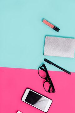 Womens office materials on pink and blue background. Flat lay, Top view