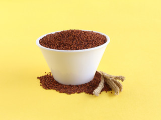 Ragi or finger millet, which is a healthy food and is said to prevent or help manage diabetes and a rich source of plant-based calcium, in a bowl and a stalk next to it.