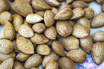 Top colorful shoot of cracked tasty fresh almonds